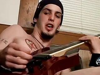 Twink shows his guitar off while stroking his hairy cock