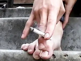 Kinky blond twink teases with his feet while smoking outdoor
