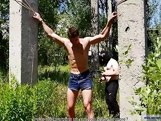 Sexy buff guy gets tortured in the forest 